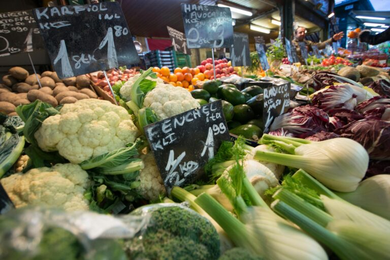 A vibrant display of fresh vegetables at a local market stall, showcasing a variety of produce.